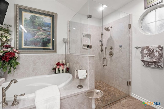 bathroom featuring a garden tub, tile patterned flooring, and a stall shower