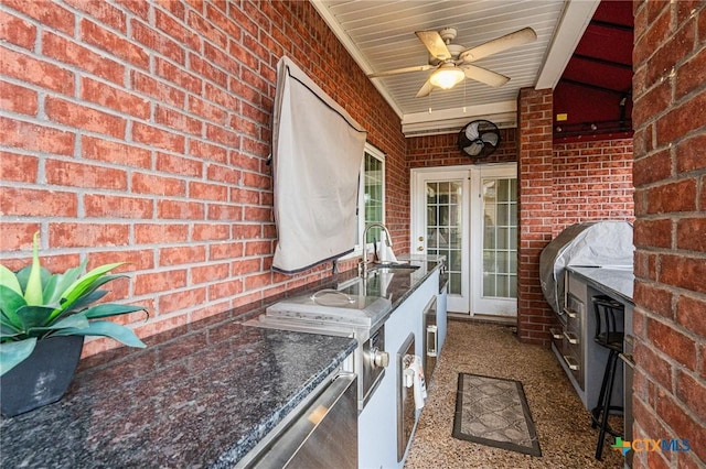 view of patio / terrace with exterior kitchen, a sink, and ceiling fan