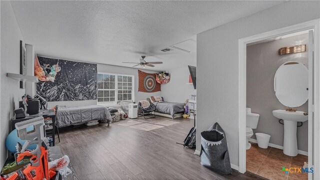 1944 Eastern Finch, New Braunfels, TX 78130 - bedroom featuring a textured ceiling, wood finished floors, and ceiling fan