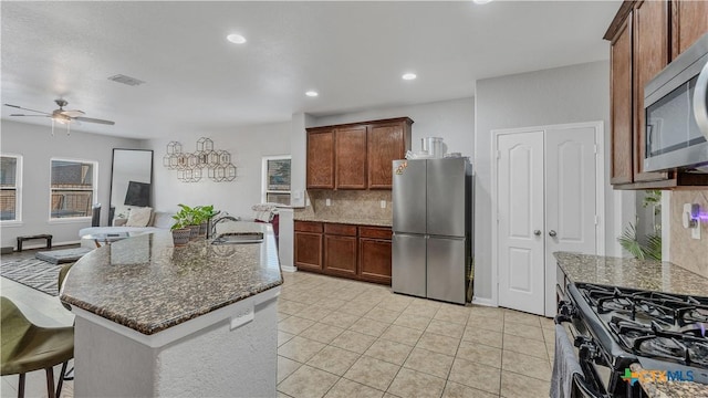 1944 Eastern Finch, New Braunfels, TX 78130 - kitchen with stainless steel appliances, tasteful backsplash, a ceiling fan, dark stone counters, and recessed lighting