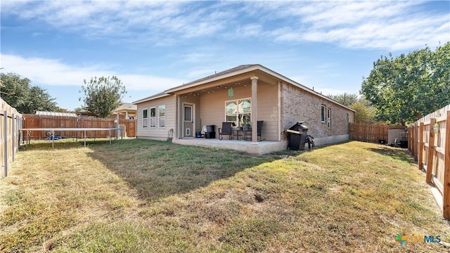 1944 Eastern Finch, New Braunfels, TX 78130 - rear view of property with a trampoline, a patio area, and a fenced backyard