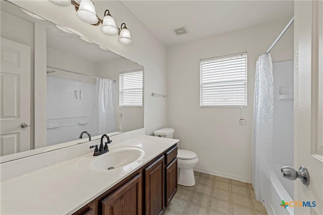 full bathroom featuring vanity, toilet, shower / bath combo, and a wealth of natural light