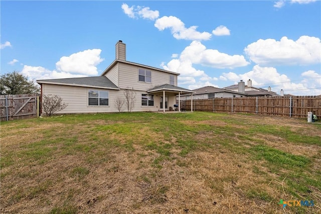 rear view of house featuring a patio and a lawn