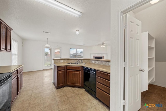 kitchen with plenty of natural light, sink, pendant lighting, and black appliances