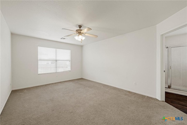 carpeted empty room with ceiling fan