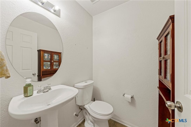 bathroom featuring sink and toilet