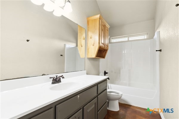 full bathroom with vanity, toilet, shower / bathtub combination, and lofted ceiling