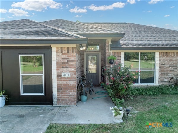 view of exterior entry featuring a patio