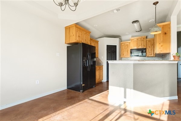 kitchen with black appliances, concrete floors, decorative backsplash, a breakfast bar area, and kitchen peninsula