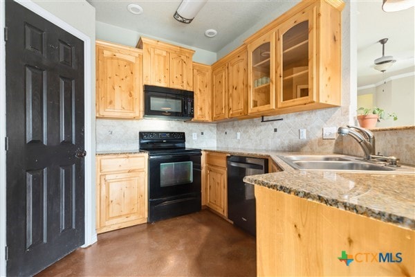 kitchen featuring black appliances, sink, backsplash, light stone countertops, and light brown cabinets