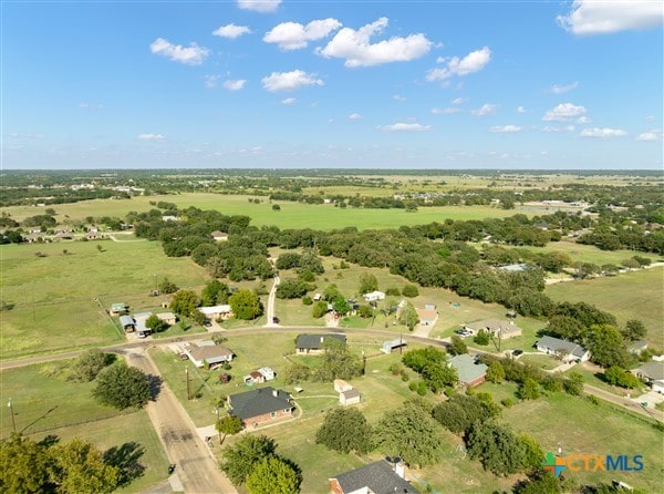 birds eye view of property with a rural view