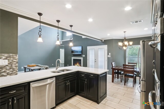11611 Quarter Horse Trl, Austin, TX 78750 - kitchen with stainless steel appliances, light countertops, dark cabinets, decorative backsplash, and crown molding