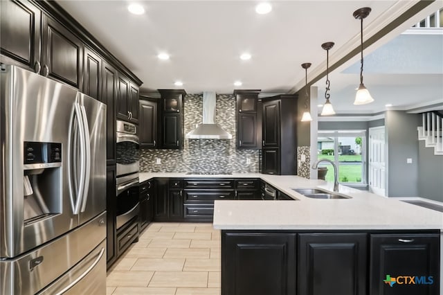 11611 Quarter Horse Trl, Austin, TX 78750 - kitchen with appliances with stainless steel finishes, wall chimney range hood, a peninsula, tasteful backsplash, and dark cabinets