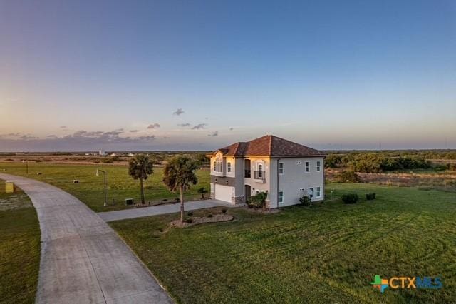 261 E Burgundy Bay Prt, Oconnor, TX 77982 - view of front of house with driveway, a front yard, and an attached garage
