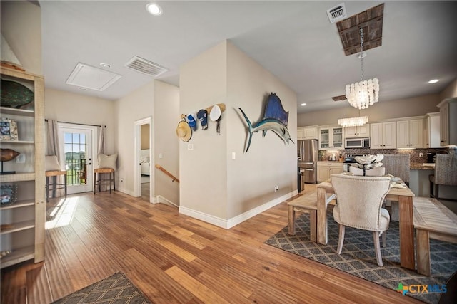 261 E Burgundy Bay Prt, Oconnor, TX 77982 - dining space featuring attic access, wood finished floors, visible vents, and recessed lighting