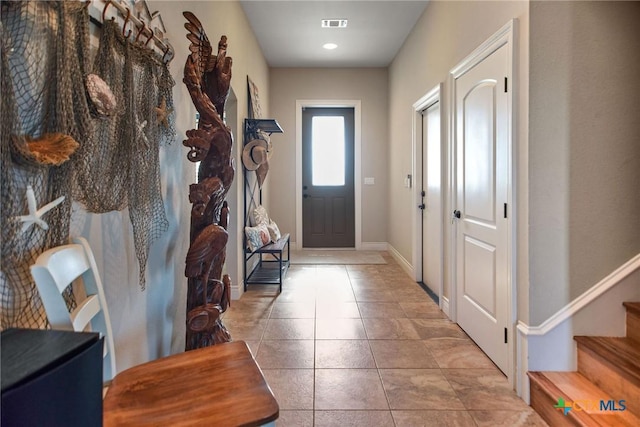 261 E Burgundy Bay Prt, Oconnor, TX 77982 - interior space with baseboards, visible vents, and stairs