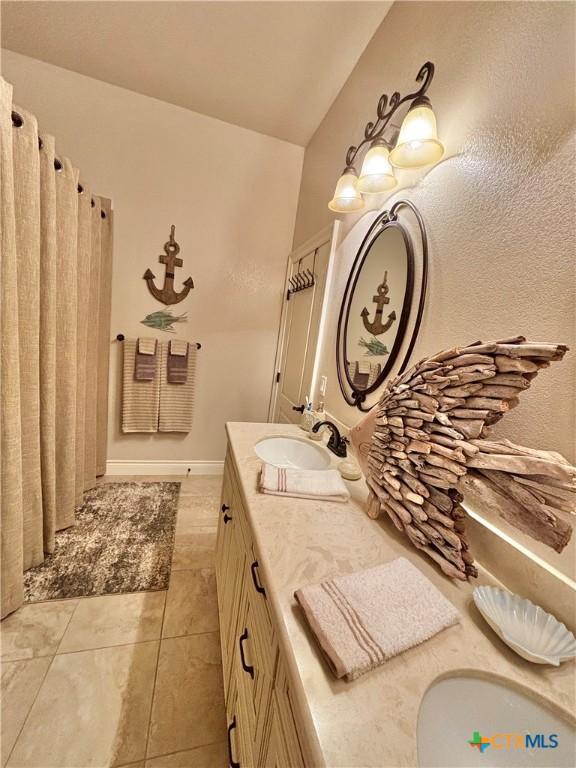 261 E Burgundy Bay Prt, Oconnor, TX 77982 - full bathroom featuring a sink, tile patterned flooring, and double vanity