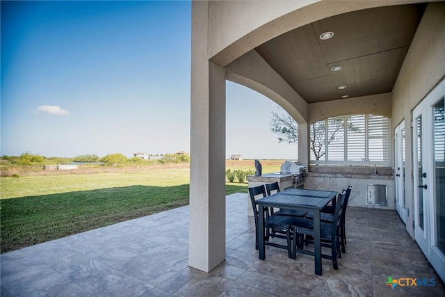 261 E Burgundy Bay Prt, Oconnor, TX 77982 - view of patio / terrace with area for grilling and outdoor dining area