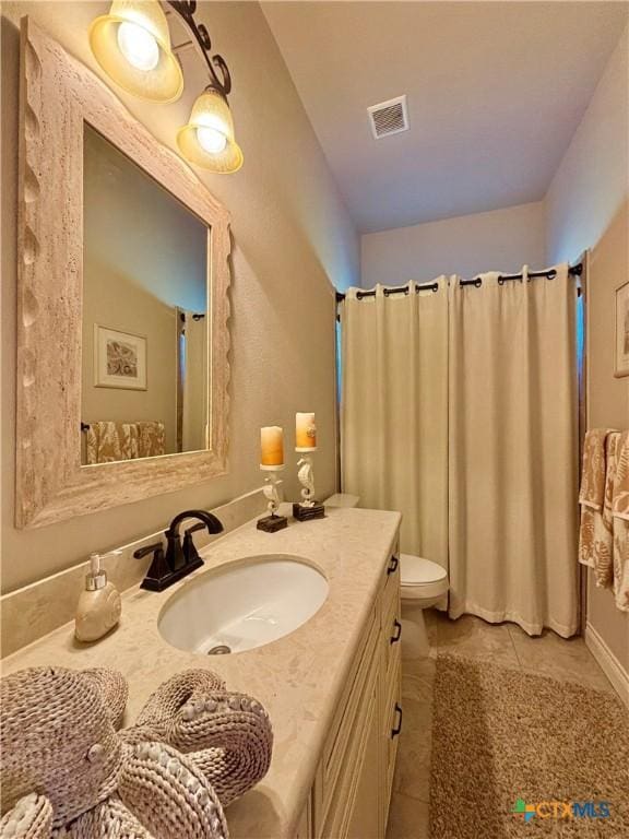 261 E Burgundy Bay Prt, Oconnor, TX 77982 - bathroom with toilet, vanity, tile patterned floors, and visible vents