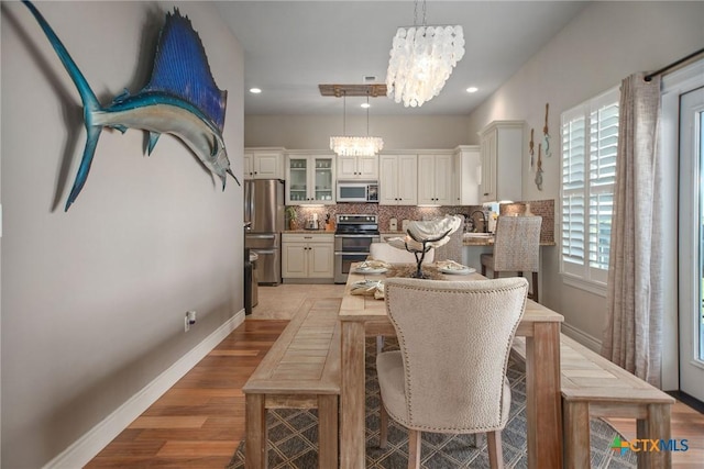 261 E Burgundy Bay Prt, Oconnor, TX 77982 - dining space with recessed lighting, baseboards, light wood-style floors, and a chandelier