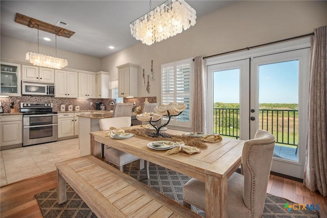 261 E Burgundy Bay Prt, Oconnor, TX 77982 - dining space featuring visible vents, a chandelier, and light wood-style floors