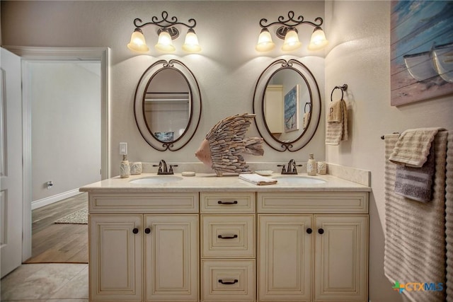 261 E Burgundy Bay Prt, Oconnor, TX 77982 - full bathroom with double vanity, wood finished floors, and a sink