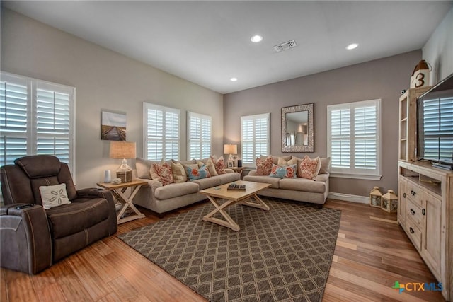 261 E Burgundy Bay Prt, Oconnor, TX 77982 - living room with recessed lighting, wood finished floors, visible vents, and baseboards