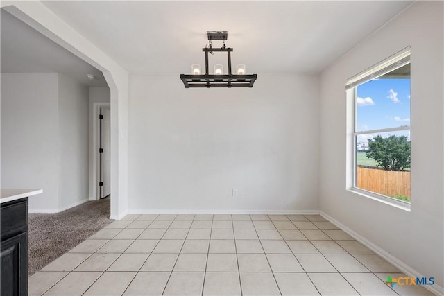 6008 Horne Dr, Killeen, TX 76542 - unfurnished dining area with arched walkways, a chandelier, and baseboards