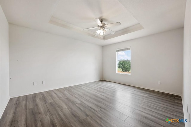 6008 Horne Dr, Killeen, TX 76542 - unfurnished room with a ceiling fan, baseboards, wood finished floors, and a tray ceiling