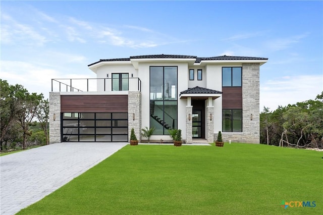4997 Comanche Dr, Temple, TX 76502 - contemporary house featuring stairs, a front lawn, stone siding, stucco siding, and driveway