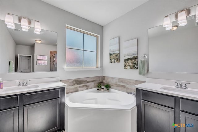 5010 Fallen Tree Dr, Temple, TX 76502 - full bathroom with two vanities and a garden tub