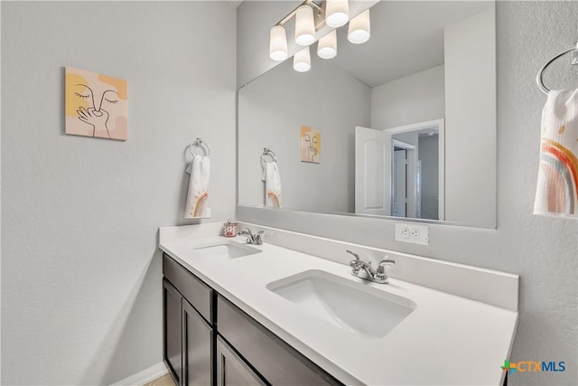 5010 Fallen Tree Dr, Temple, TX 76502 - full bathroom featuring double vanity, a chandelier, and a textured wall