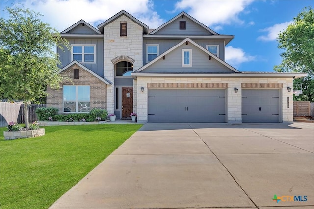 5010 Fallen Tree Dr, Temple, TX 76502 - view of front of home with driveway, an attached garage, board and batten siding, and brick siding