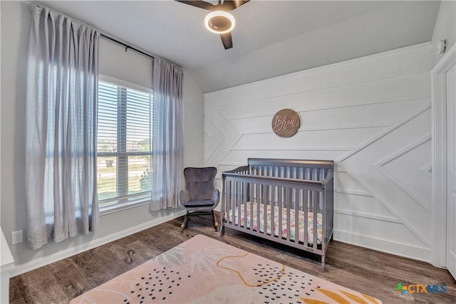 5010 Fallen Tree Dr, Temple, TX 76502 - bedroom featuring multiple windows, wood finished floors, a crib, and lofted ceiling