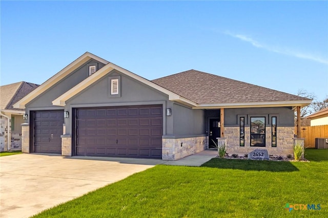 view of front of property featuring a front yard, a garage, and cooling unit