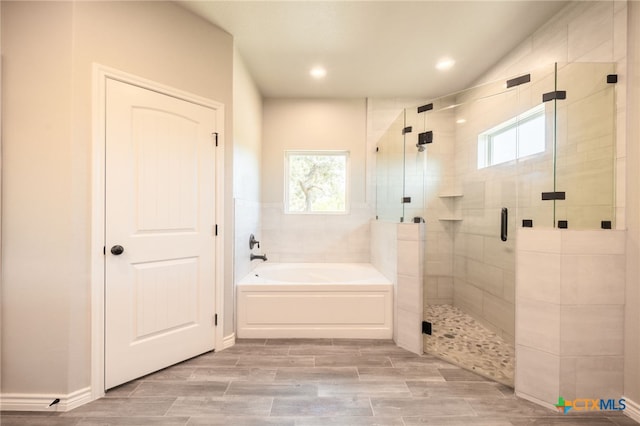 full bathroom featuring recessed lighting, a garden tub, and a shower stall