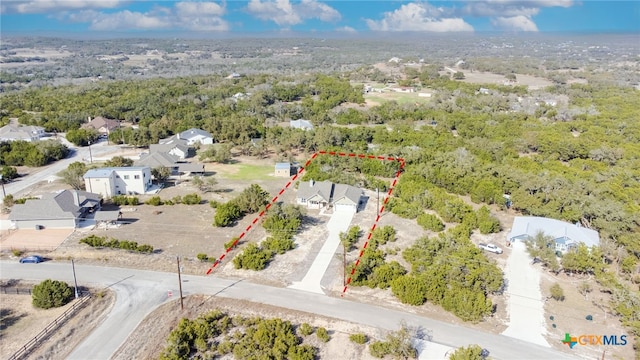 bird's eye view featuring a forest view and a residential view