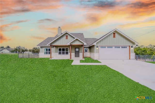 craftsman house with an attached garage, fence, driveway, a front lawn, and a chimney