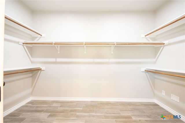 walk in closet featuring wood tiled floor