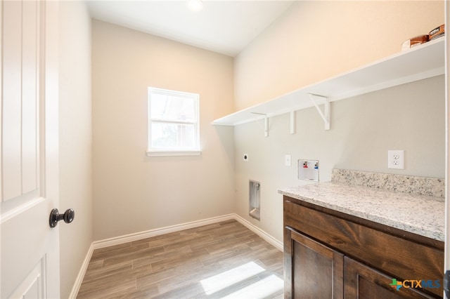 washroom featuring baseboards, light wood-style floors, washer hookup, and hookup for an electric dryer