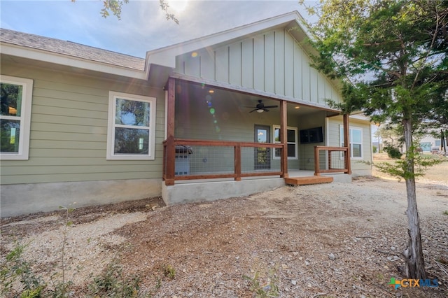 rear view of property featuring a porch, board and batten siding, and a ceiling fan