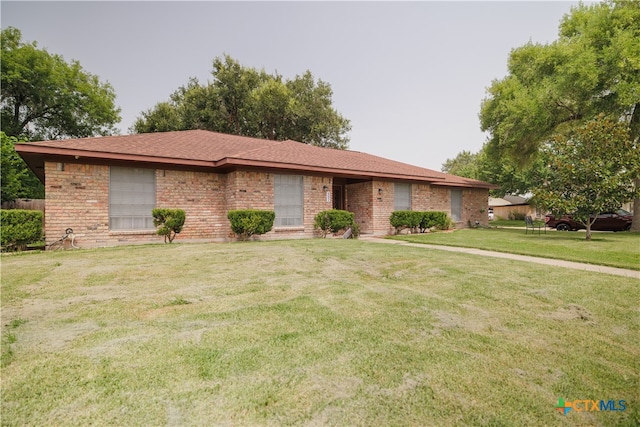 ranch-style home with a front lawn