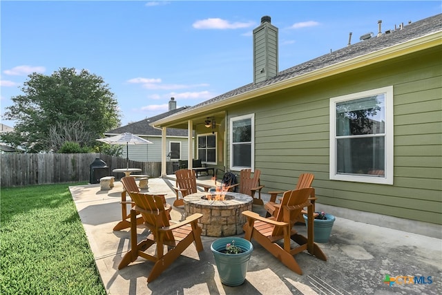 view of patio / terrace with fence and an outdoor fire pit