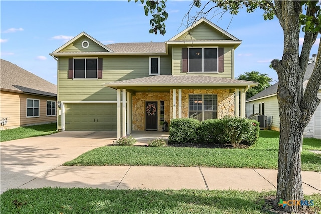 traditional home featuring a shingled roof, central AC, stone siding, a garage, and concrete driveway