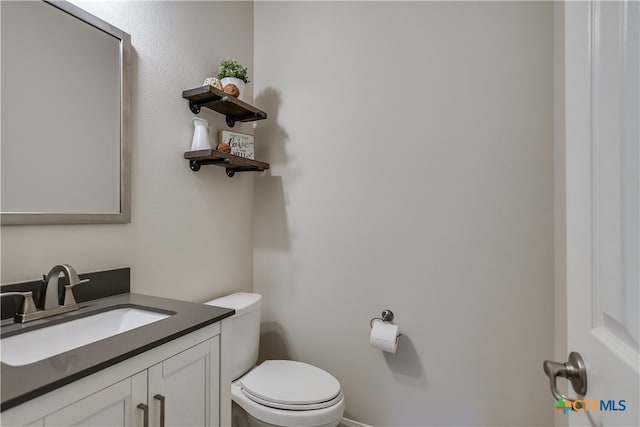 half bath with vanity and toilet