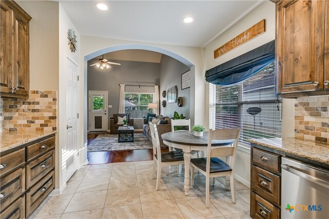1122 Boxwood Loop, Georgetown, TX 78628 - living room with high vaulted ceiling, ceiling fan, a tile fireplace, wood finished floors, and baseboards