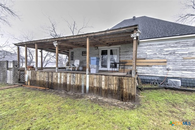 exterior space featuring a lawn and french doors