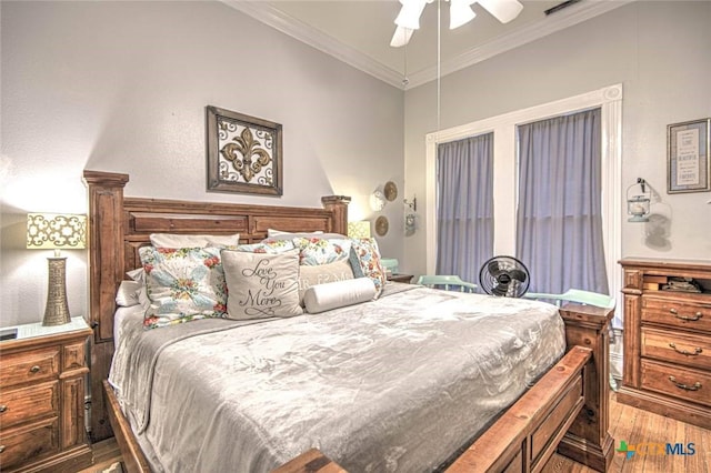 bedroom with crown molding, dark hardwood / wood-style floors, and ceiling fan