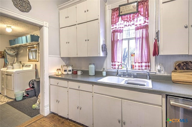 kitchen with sink, white cabinetry, stainless steel dishwasher, dark hardwood / wood-style floors, and independent washer and dryer