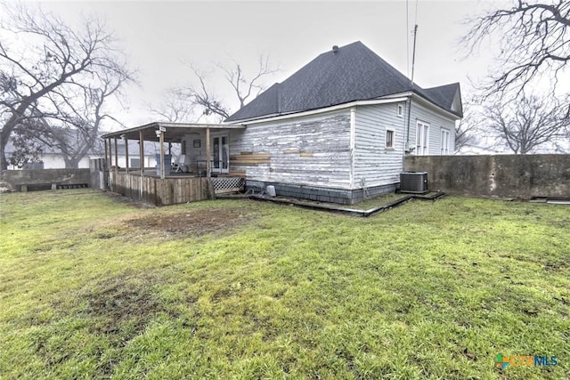 back of property featuring a yard and central air condition unit